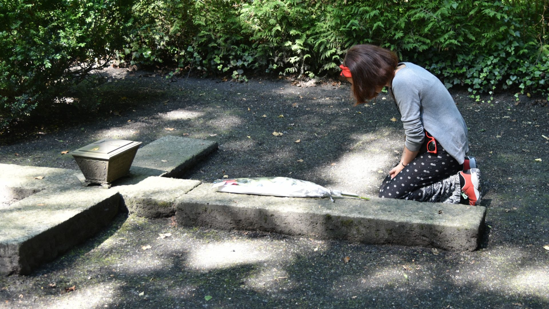 Louisa se recueille sur la tombe où est enterré son arrière-grand oncle (Photo: Raphaël Zbinden)