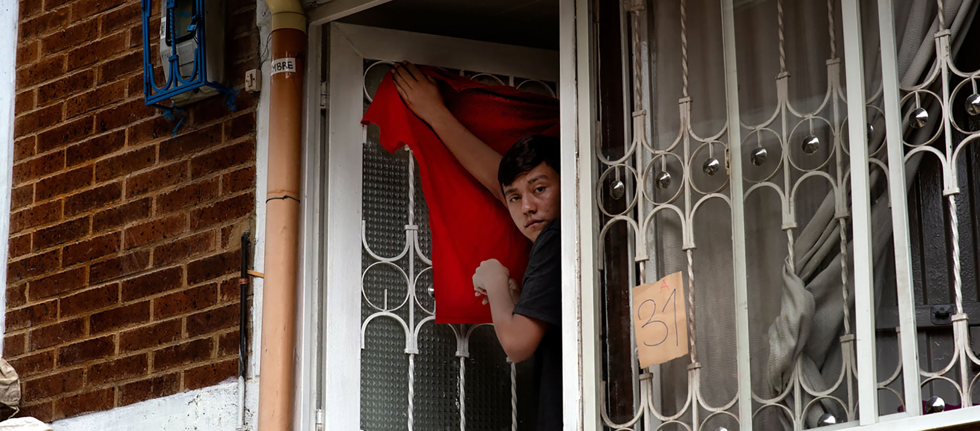 De nombreuse familles qui ne peuvent plus se nourrir ont accroché des tissus rouges aux fenêtres de leur habitation pour interpeler le gouvernement | © Keystone/L. C. Ayala