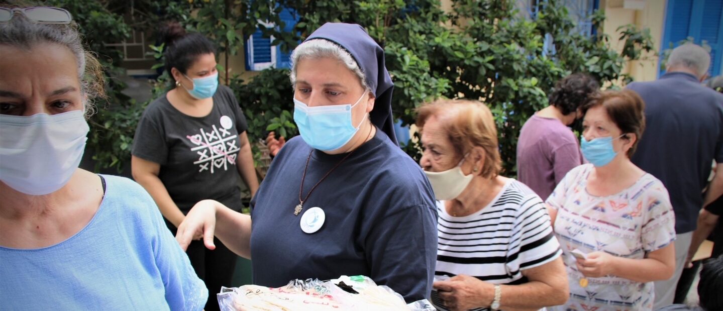 Sister Rita distributing ACN support for families affected by the explotion and poverty in Karm Al Zeytoun