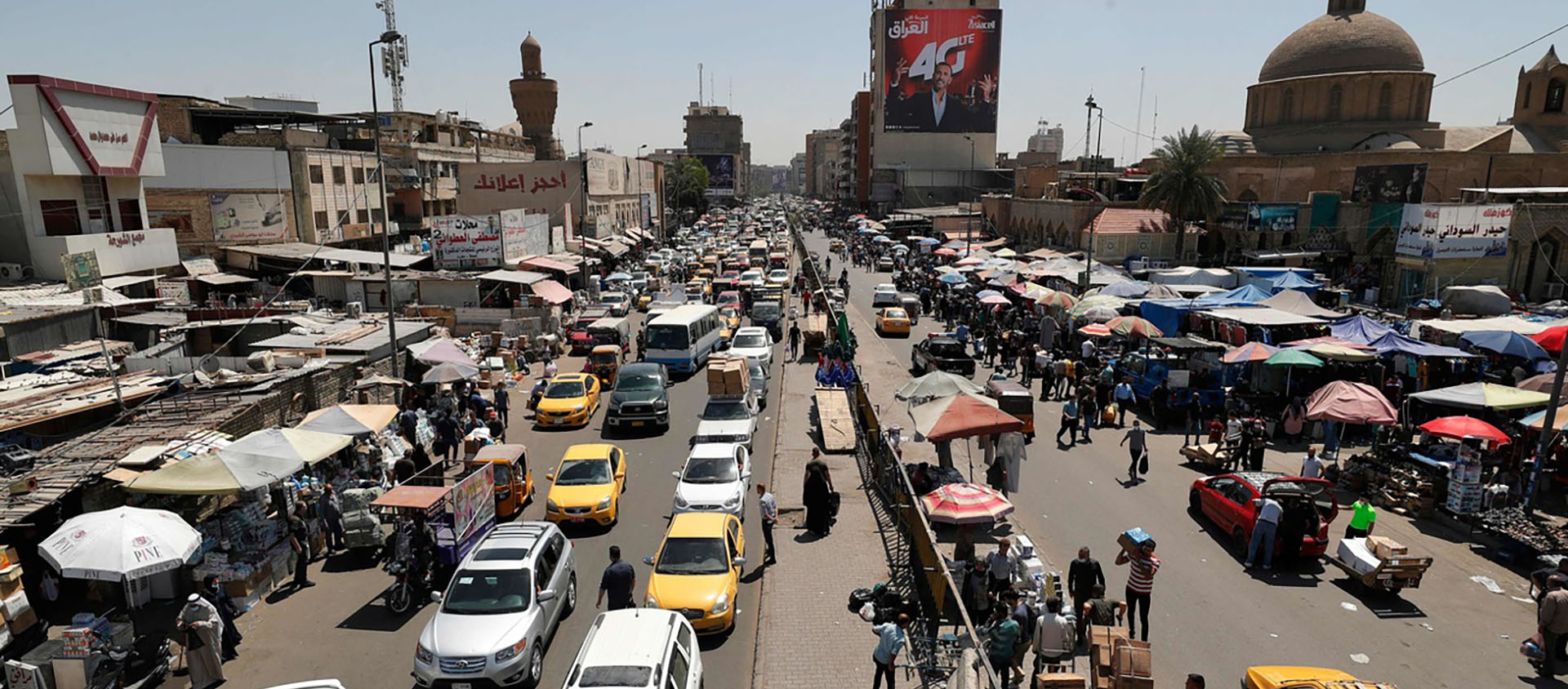 Scène de rue à Bagdad en Irak où la participation au scrutin législatif d'octobre inquiète alors que les chrétiens appellent au boycott des élections | © Keystone/AFP/ Ahmad AL-Rubaye 