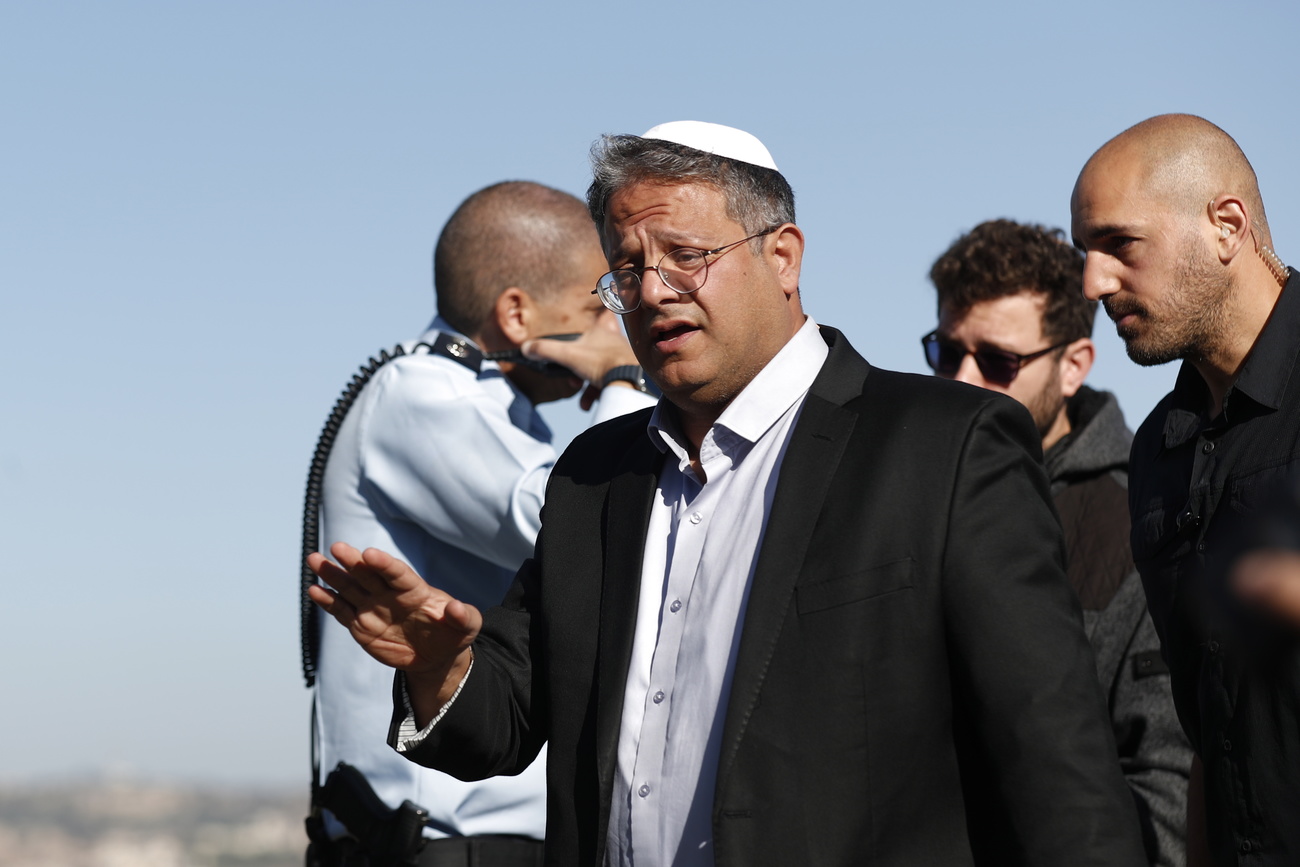 epa10321753 Israeli far-right lawmaker Itamar Ben-Gvir (C) inspects the site of explosion at a bus stop near entrance to Jerusalem, Israel, 23 November 2022. According to Israeli police, at least 14 people were injured in two explosions at two bus stops at the Givat Shaul Junction and near Ramot Junction in Jerusalem. Israel Police forces rushed to both scenes, collecting evidence and testimonials, and taking action to locate possible suspects. EPA/ATEF SAFADI