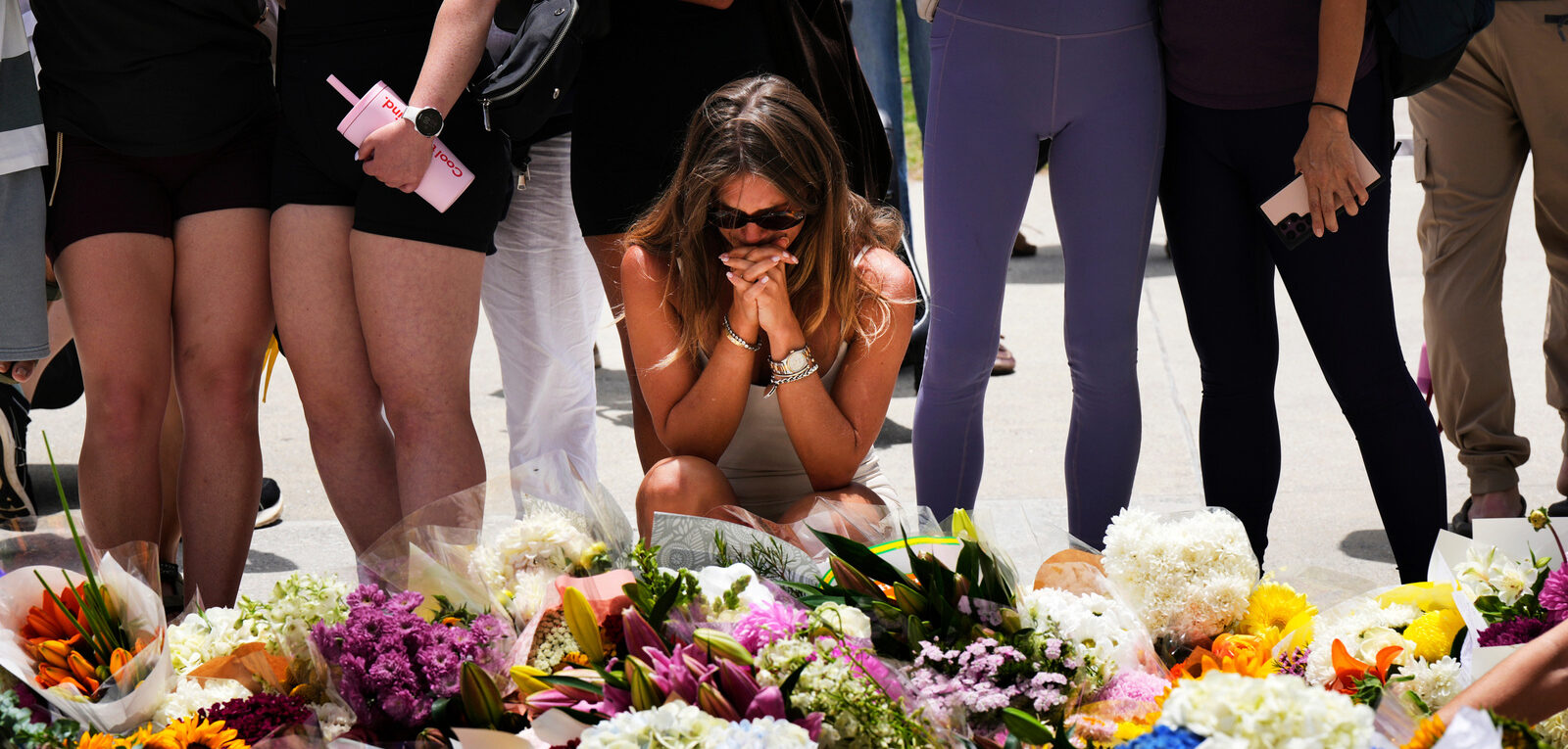 Une femme se recueille à Bondi Beach (Australie) après l'attaque terroriste du 14 décembre 2025 | © Mark Baker/AP/Keystone